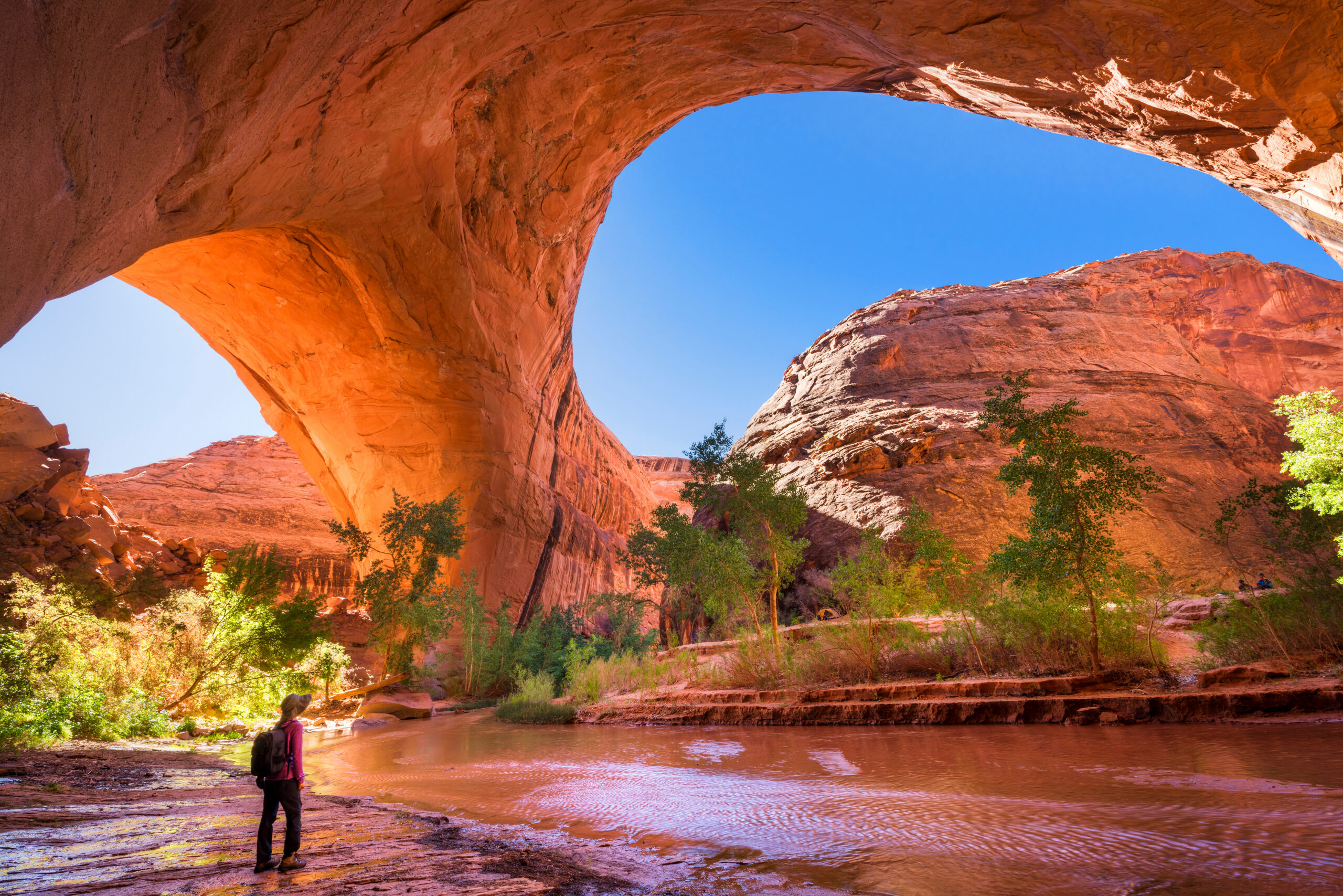 A hiker under Jacob Hamblin Arch in Coyote Gulch, Grand Staircase-Escalante National Monument